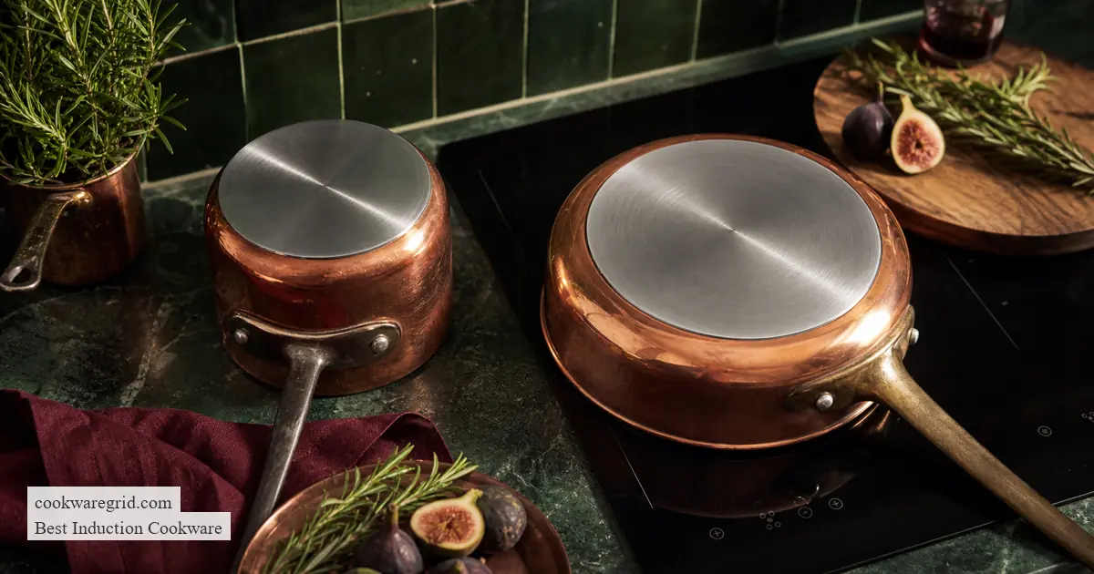 Copper pans turned over to show broad magnetic stainless steel bases for induction cooking