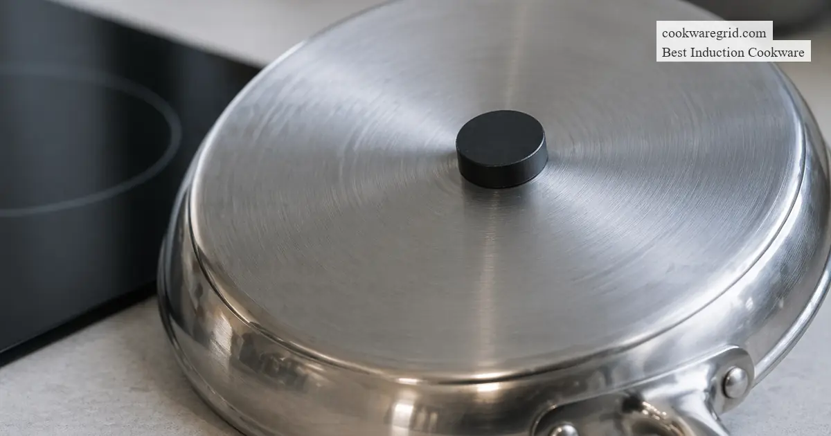 A sleek stainless steel induction pan on a modern glass cooktop